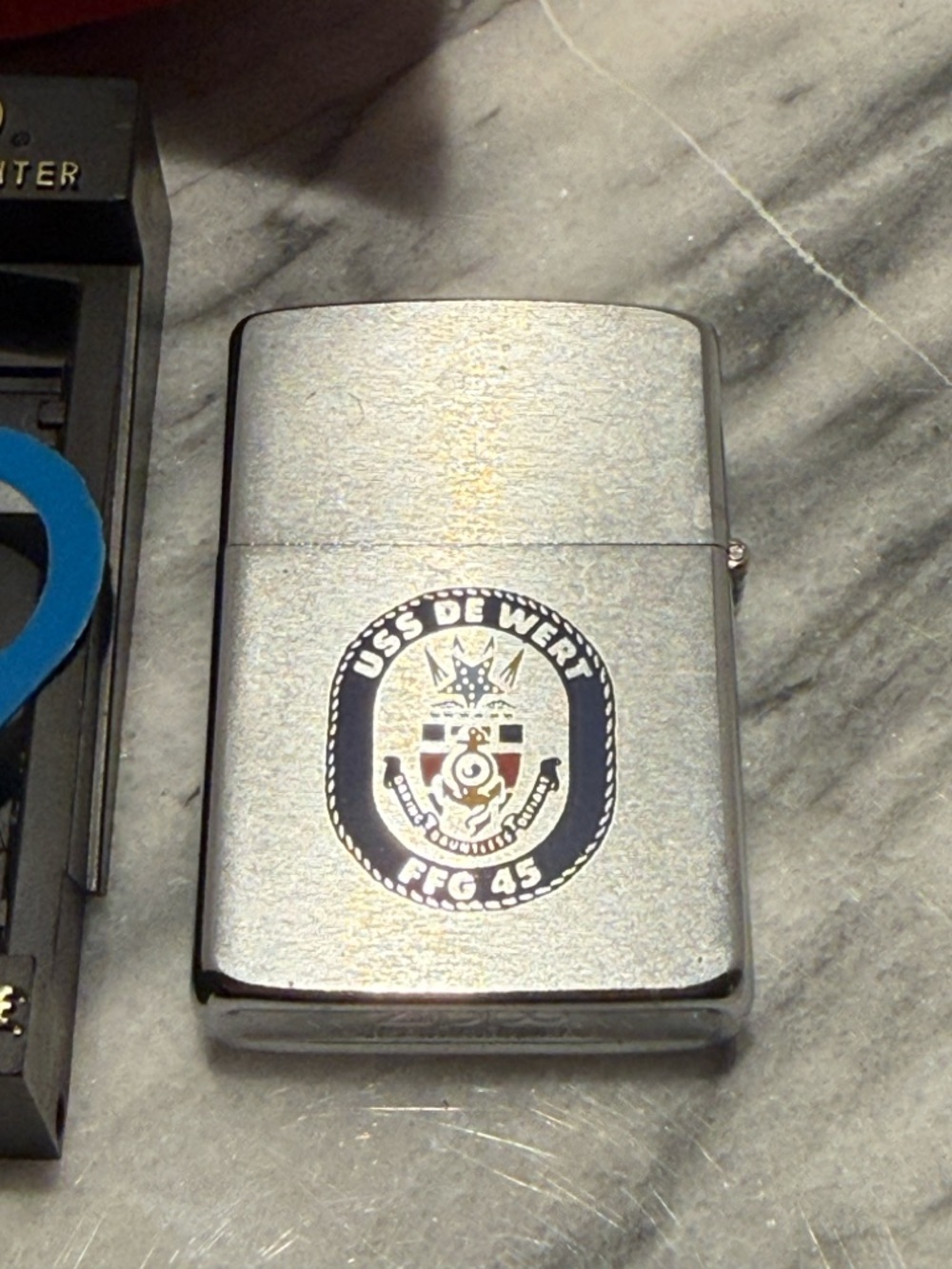 Vintage 70’s Zippo lighter featuring the emblem of the USS De Wert (FFG-45)
